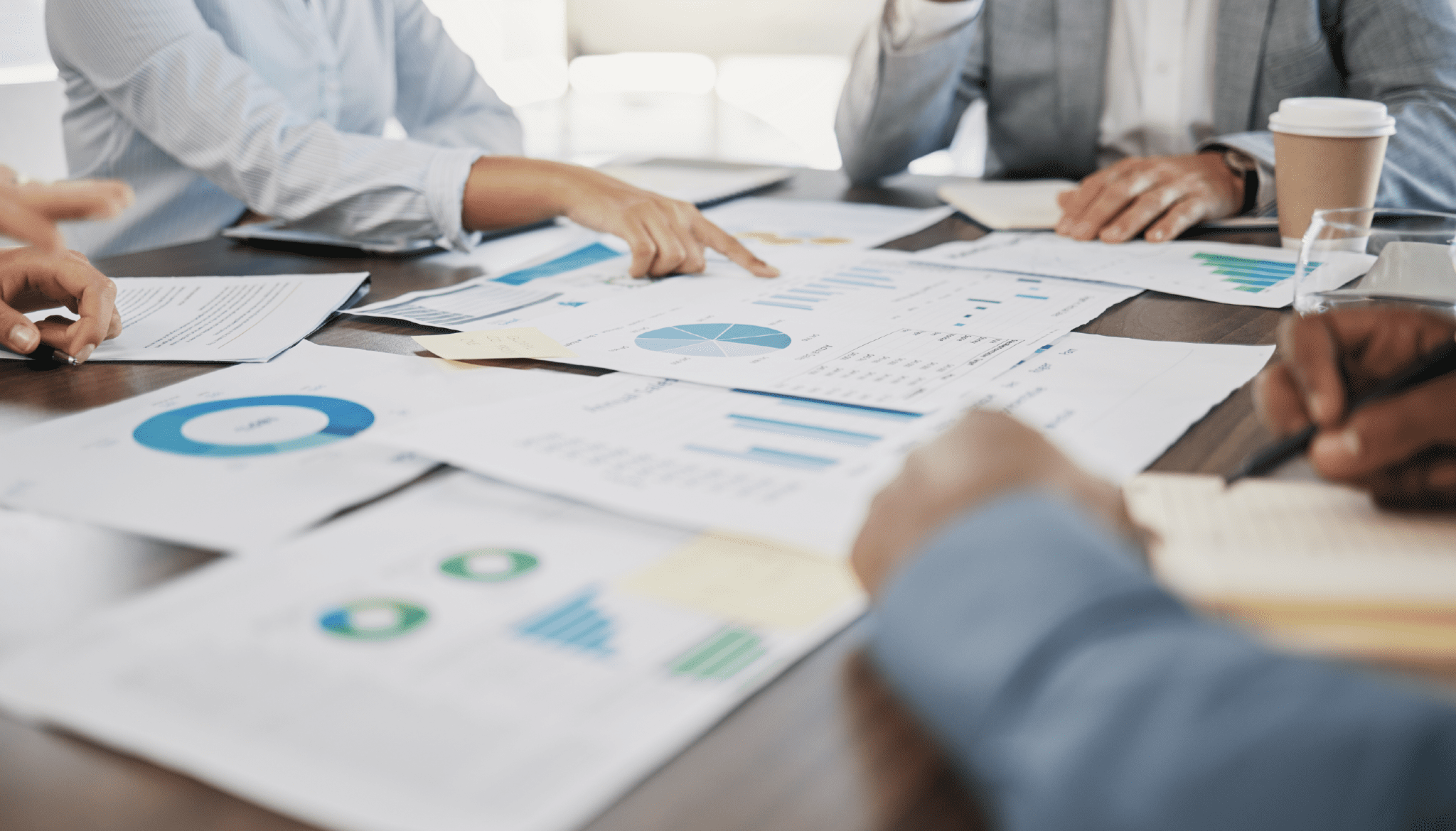 People reviewing finance reports for driver based modeling