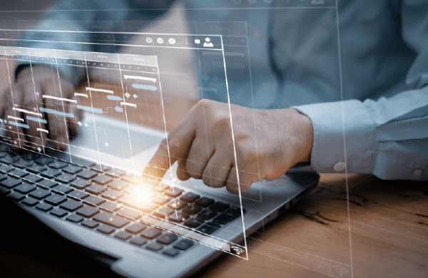 Image of hands at a keyboard with transparent work screen overlay. Article: Mythbusting Managed Services for Cloud