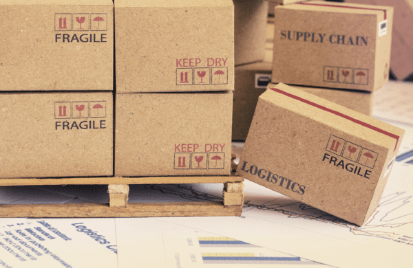 Picture boxes on a palette with labels 'logistics' and 'supply chain'.